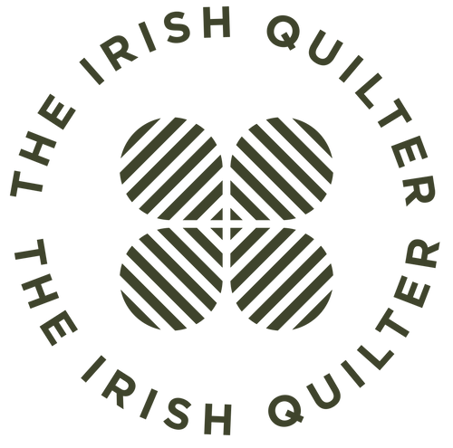 The Irish Quilter's logo, joins the symbol of design with the four leaved clover. The green design resonates with quilters and those interested in learning how to quilt and sew with the quilt pattern designer's Workshop, classes & online quilt tutorials  